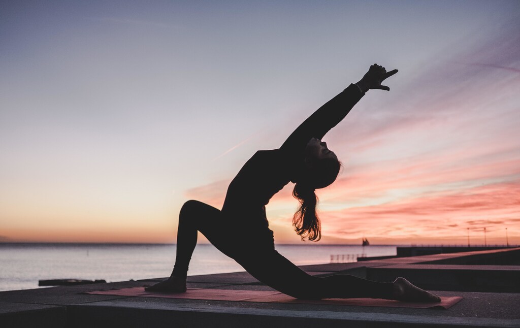 Woman stretching at twilight
