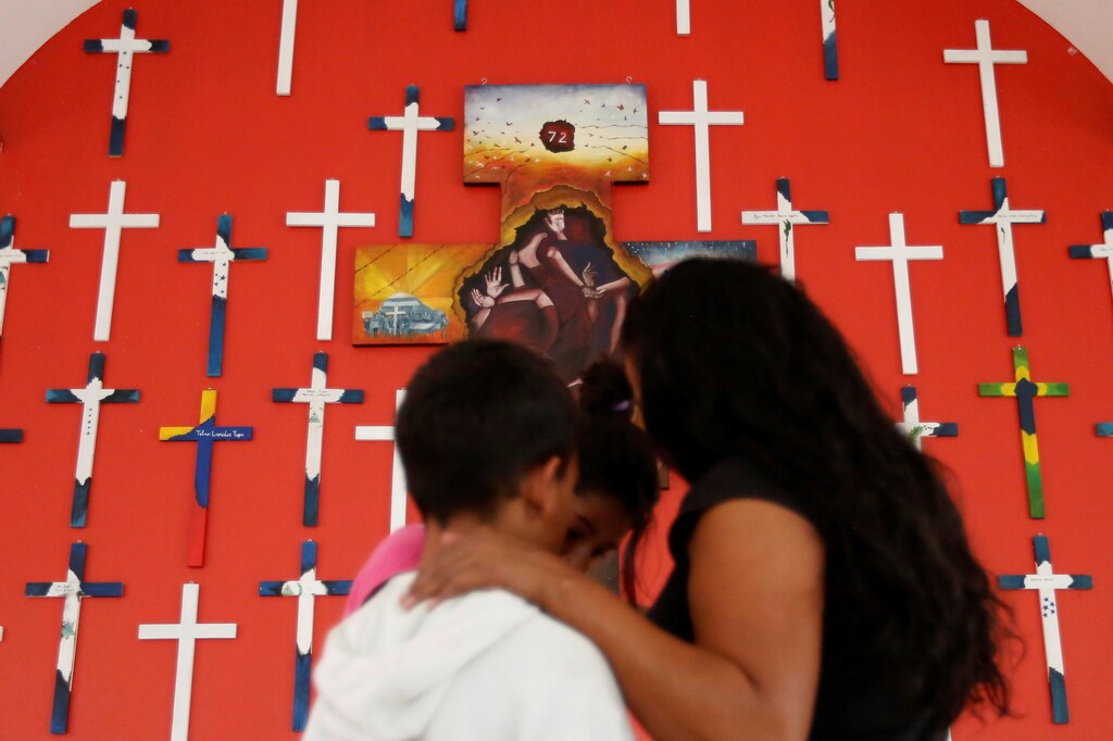 A woman from Honduras, 40, who didn't want to be identified and who is hoping to get refugee status in Mexico, poses for a photograph with her children at a migrant shelter, known as The 72, in Tenosique, Tabasco, Mexico, April 12, 2017. "I left Honduras because of violence, threats and extortion. I was tired working really hard and giving my money to the gangs weekly," she said. REUTERS/Carlos Jasso SEARCH "IMMIGRANTS JASSO" FOR THIS STORY. SEARCH "WIDER IMAGE" FOR ALL STORIES. - RTS15ANX