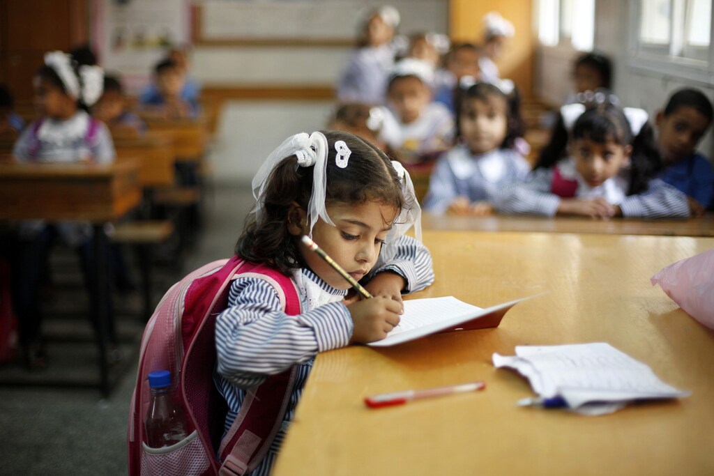 Palestinian schoolchildren attend a class at a U.N.-run school in Dir al-Balah in the central Gaza Strip, on the first day of the school year August 25, 2013.