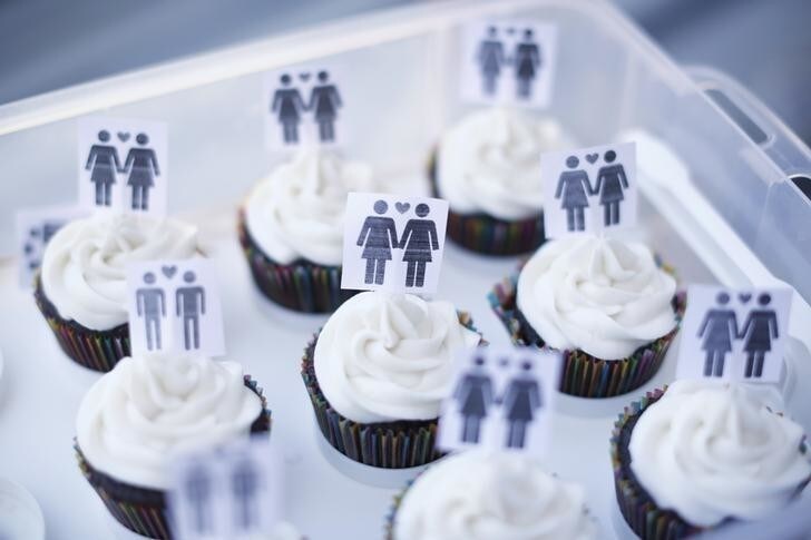 A box of cupcakes are seen topped with icons of same-sex couples at City Hall in San Francisco, June 29, 2013. Same-sex couples rushed to San Francisco's City Hall on Saturday to be legally married after the U.S. Ninth Circuit Court of Appeals officially ended California's ban on gay marriage following a landmark ruling at the Supreme Court this week. REUTERS/Stephen Lam (UNITED STATES - Tags: SOCIETY POLITICS FOOD)