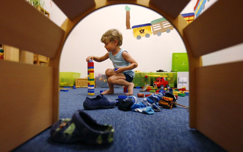 A four year-old boy plays at a nursery.