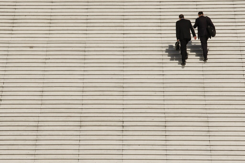 Businessmen climb the steps at the Arche de la Defense, the financial and business district west of Paris.