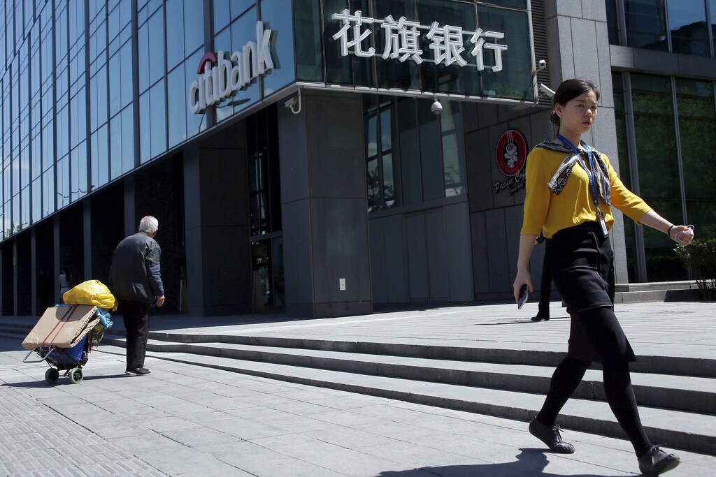 People walk past a branch of Citibank in Beijing, China, April 18, 2016. REUTERS/Kim Kyung-Hoon - RTX2AKND
