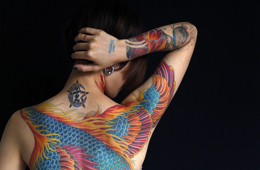 Nai, whose husband is a tattoo artist, poses for a portrait with Reuters during the 2010 Taiwan International Tattoo Convention in Taipei July 31, 2010. The convention aims to gather people from all over the world to promote the industry and garner positive thinking towards tattoos. REUTERS/Nicky Loh (TAIWAN - Tags: SOCIETY) - RTR2GZZS