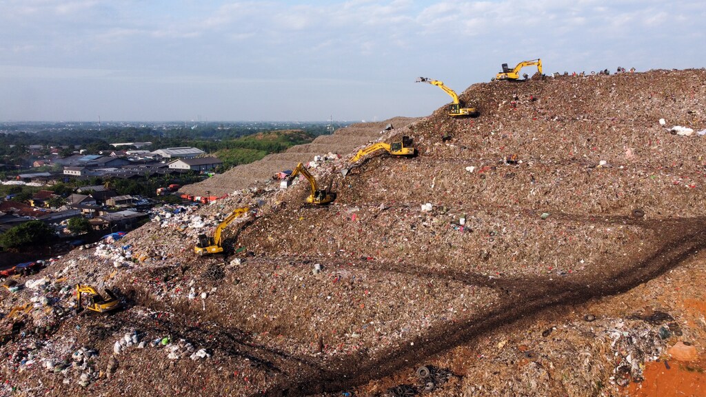 Heavy vehicles work at the Bantar Gebang landfill in Bekasi, West Java province, Indonesia.