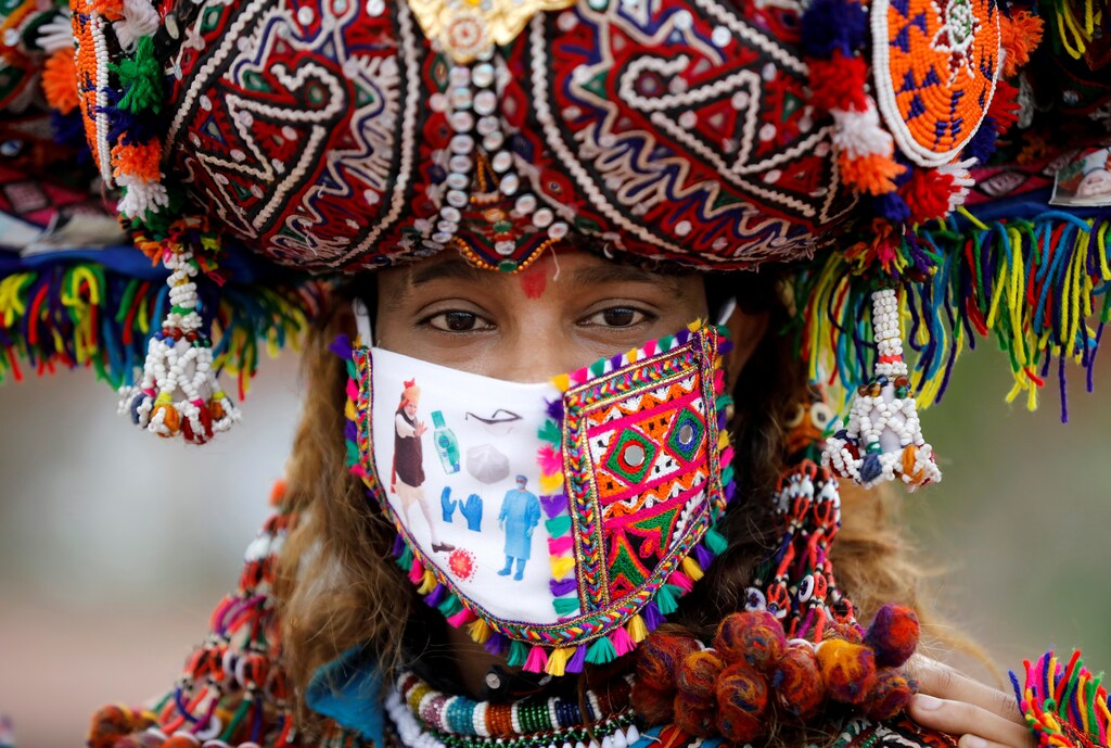 A participant in a traditional costume wearing a face mask attends a rehearsal for Garba, a folk dance, ahead of Navratri, a festival during which devotees worship the Hindu goddess Durga and youths dance in traditional costumes, amidst the coronavirus disease (COVID-19) outbreak, in Ahmedabad, India, September 12, 2020. REUTERS/Amit Dave TPX IMAGES OF THE DAY - RC2UWI9DC85L