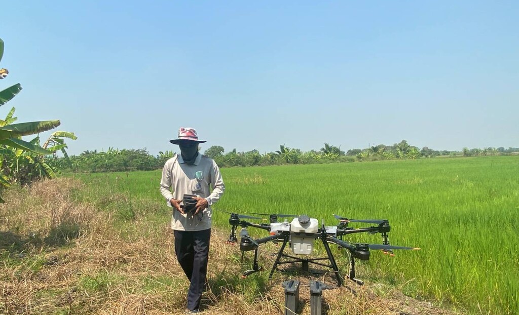 Sayan Thongthep, 52, sets up his agriculture drone to spray pesticide in a rice farm in Ban Yai, Thailand.