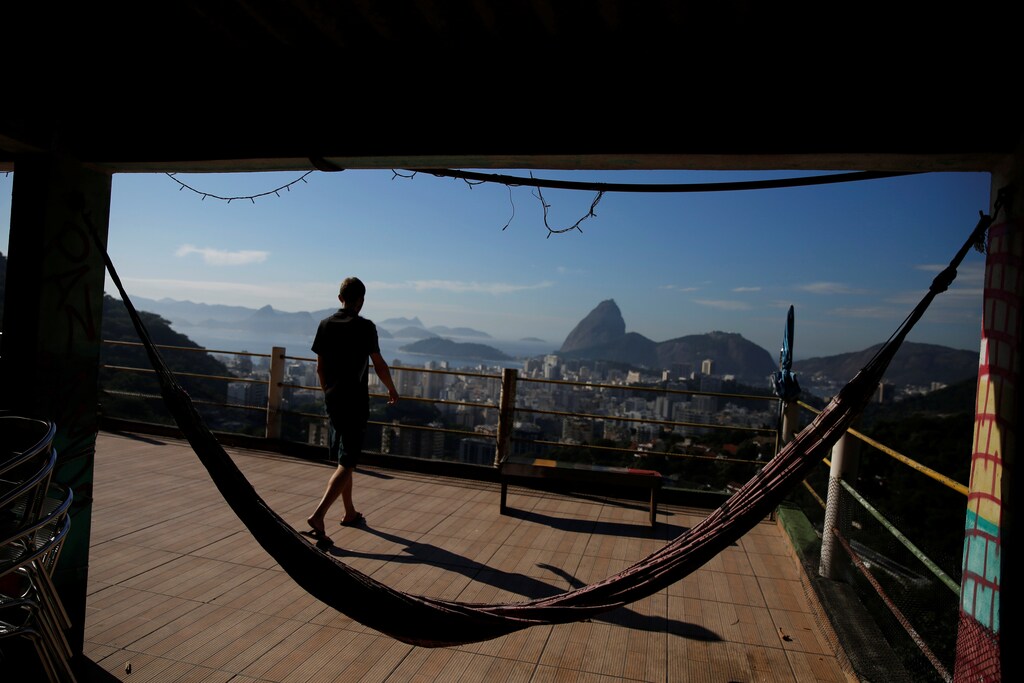 A man walks along a terrace at Pousada Favelinha (Little favela) hostel in Pereira da Silva favela, in Rio de Janeiro, Brazil, April 21, 2016.