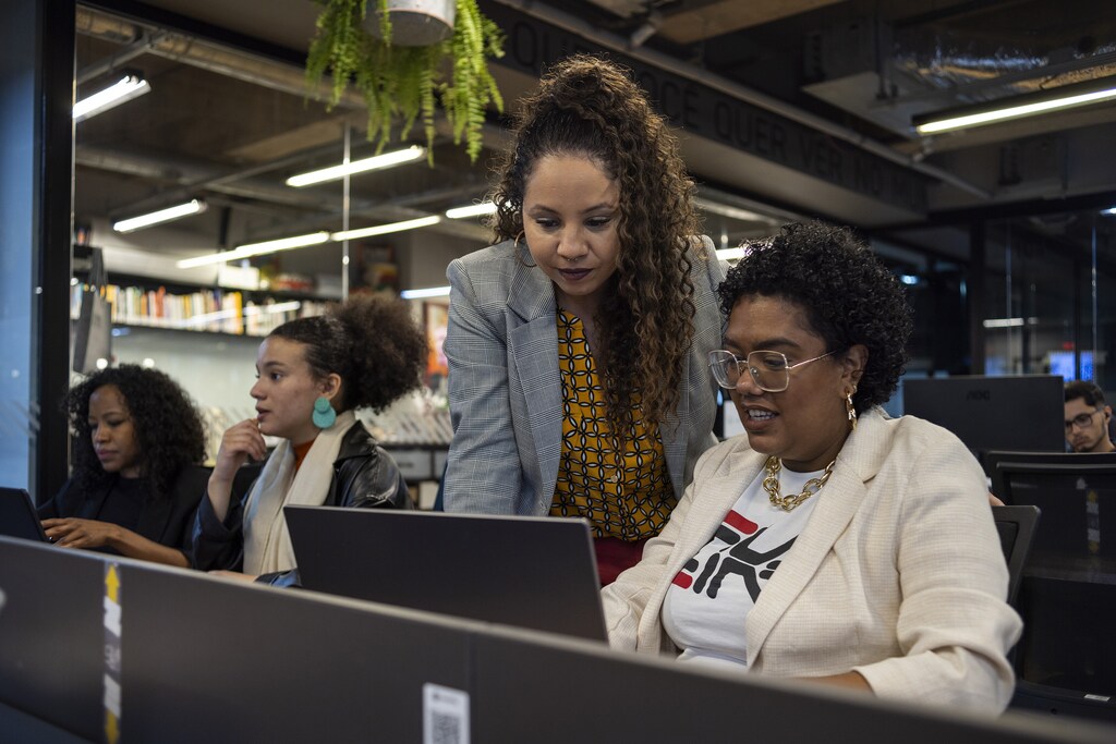 A group of women work at computers; female entrepreneurs; social economy