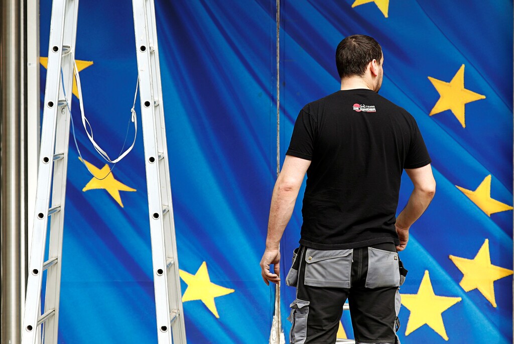 A worker is pictured in front of an entrance of the European Commission headquarters in Brussels, Belgium, April 30, 2019. REUTERS/Francois Lenoir