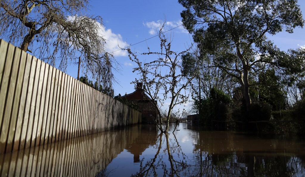 Blue skies are seen over urban landscape taken in the flooded Somerset village of Moorland February 16, 2014.