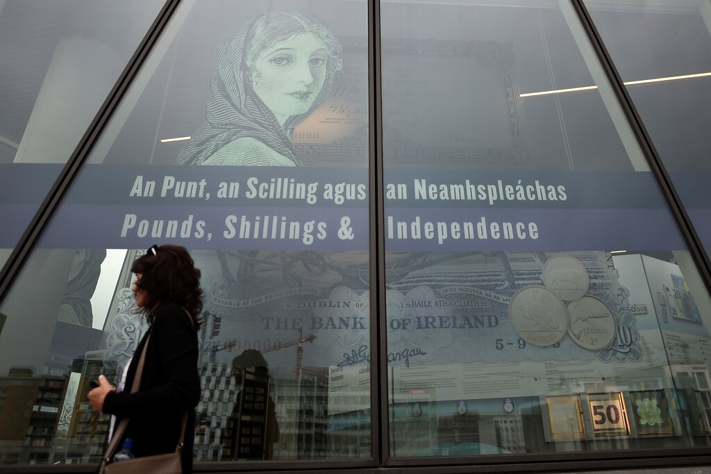A woman walks past a sign on the Central Bank in the financial services area of Dublin, Ireland July 7, 2017. REUTERS/Clodagh Kilcoyne - RTX3AJ8F