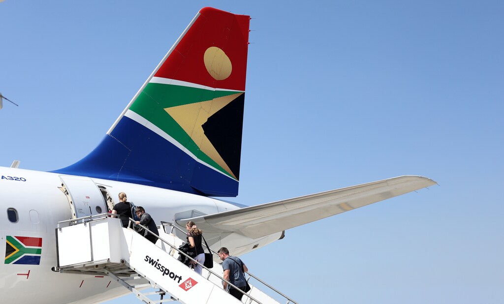 Passengers board a South African Airways plane at the Port Elizabeth International Airport in the Eastern Cape province, South Africa, September 30, 2018. REUTERS/Siphiwe Sibeko - RC19284257E0