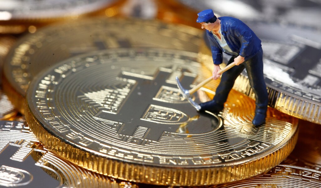A small toy figure is seen on representations of the Bitcoin virtual currency in this illustration picture, December 26, 2017. REUTERS/Dado Ruvic/Illustration - RC18DE227180