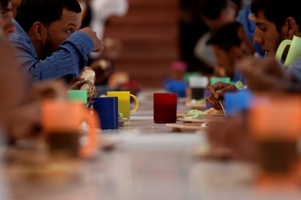 Central American migrants eat donated food inside the "Sacred Family" shelter as they make the perilous journey north to the United States, in Apizaco, Tlaxcala, Mexico April 16, 2021. Picture taken April 16, 2021.