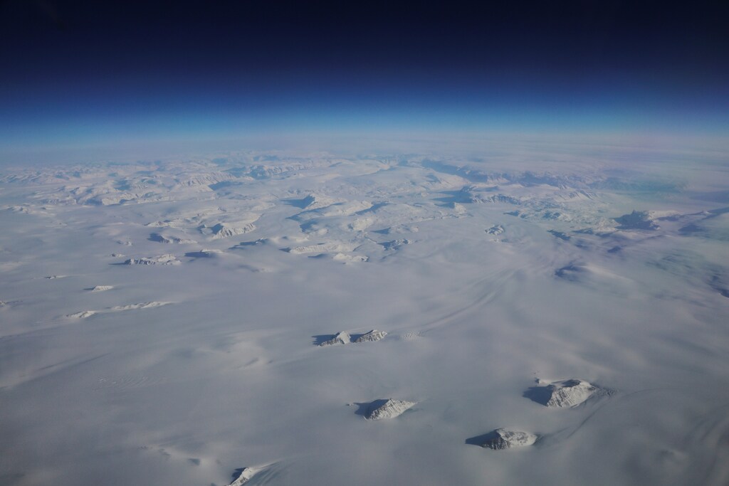Mountains stick up through a massive ice sheet covering Greenland near the eastern coast of the country, March 13, 2018. Picture taken March 13, 2018. REUTERS/Lucas Jackson - RC122BFAA460
