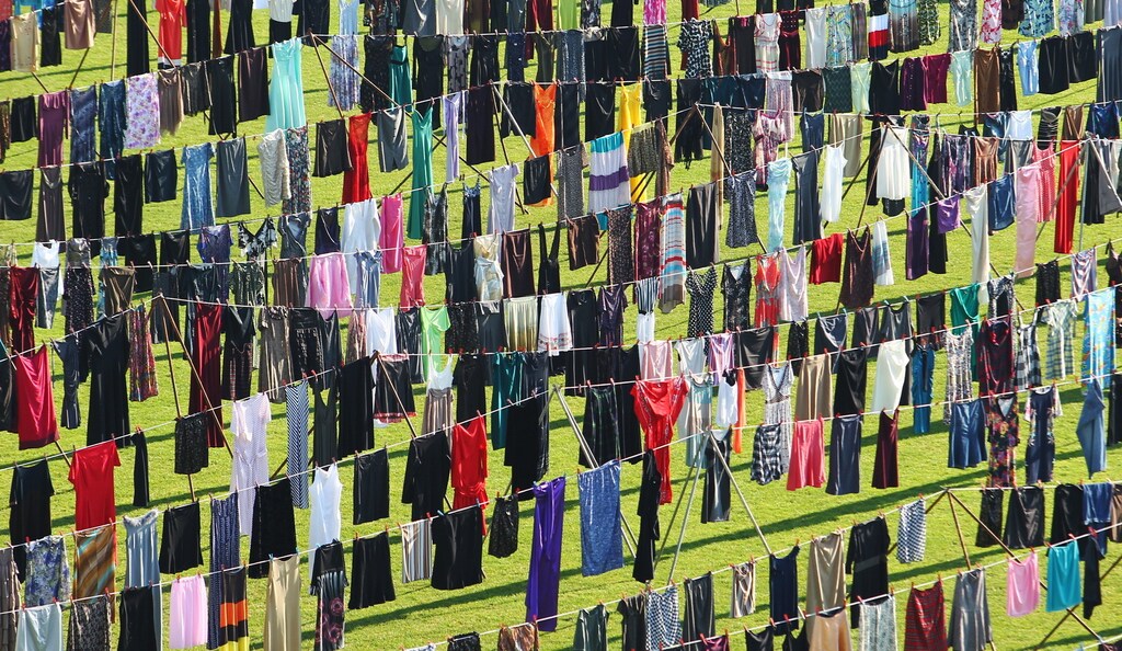 Dresses and skirts are seen hanging inside a stadium, in an art exhibition titled "Thinking of You" by Kosovo-born, London-based artist Alketa Xhafa-Mripa, in Pristina June 12, 2015. Dresses and skirts donated by Cherie Blair and Rita Ora were among 5,000 pegged to washing lines in the Kosovo stadium on Friday in the art installation drawing attention to the stigma suffered by victims of wartime sexual violence. REUTERS/Hazir Reka - GF10000125192