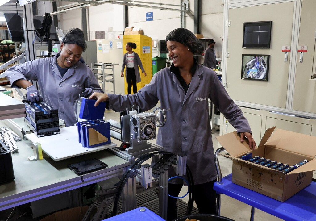 Workers interact at a Polarium energy-storage facility, where they make energy storage and optimization solutions, built on lithium-ion battery technology for businesses within telecom, commercial and industrial facilities across the world, in Cape Town, South Africa, April 5, 2023. REUTERS/Esa Alexander