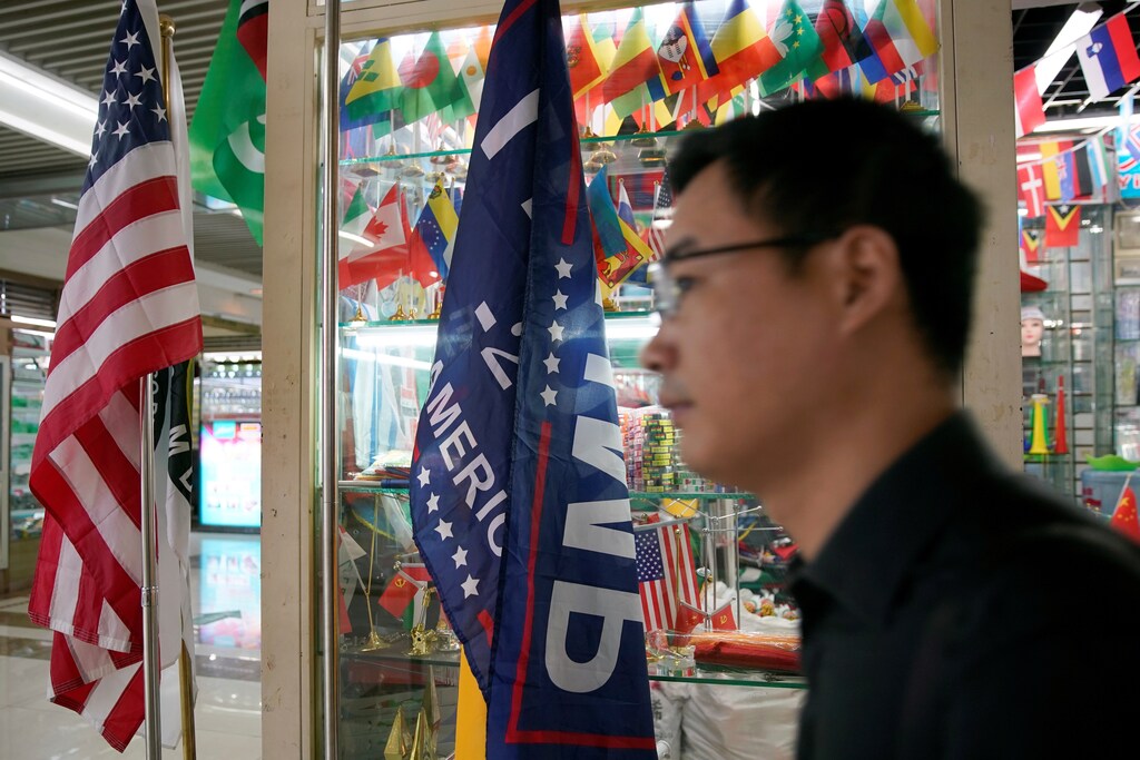 A flag of the U.S. President Donald Trump's "Keep America Great!" 2020 re-election campaign and the U.S. flag are seen in a flag stall at the Yiwu Wholesale Market in Yiwu, Zhejiang province, China, May 10, 2019. REUTERS/Aly Song - RC1C4FC93870