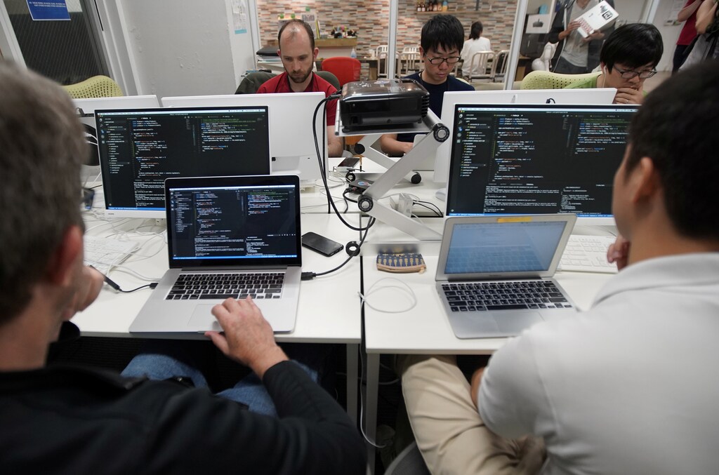Students attend Code Chrysalis, a software-coding boot camp, at a basement room in Tokyo, Japan, May 23 2018. Picture taken May 23 2018. REUTERS/Toru Hanai - RC1F42DD5780