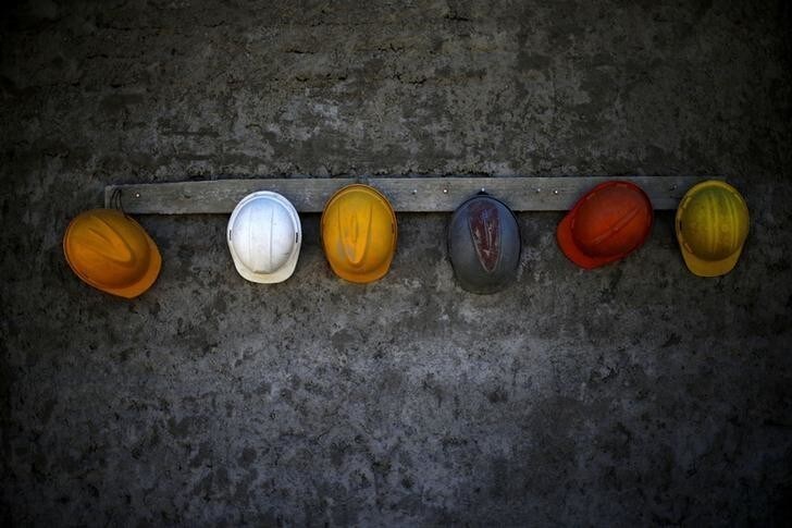 Helmets hang in a construction area in a neighborhood at Santiago, November 10, 2014. REUTERS/Ivan Alvarado (CHILE - Tags: BUSINESS CONSTRUCTION EMPLOYMENT SOCIETY TPX IMAGES OF THE DAY)