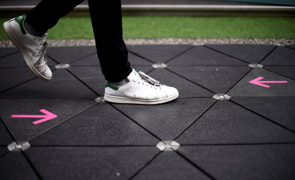 A man walks along a Pavegen technology footpath on a 'smart street' in central London, Britain, July 28, 2017. REUTERS/Hannah McKay - RC1766B80A30
