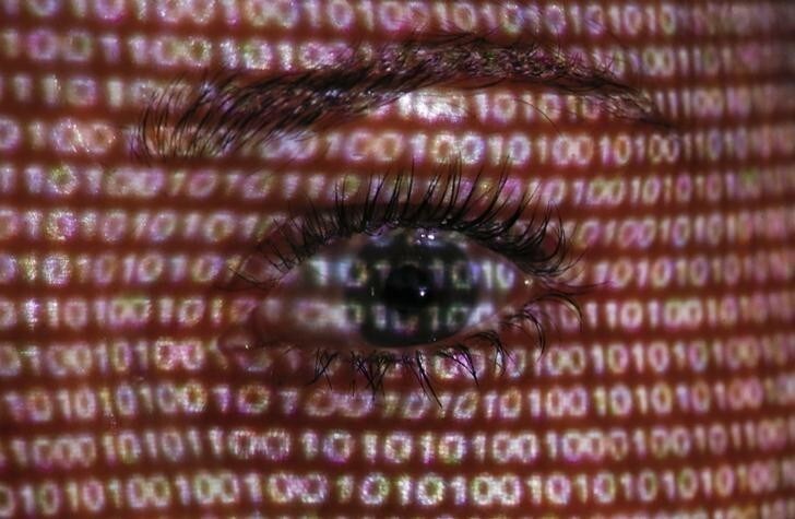 An illustration picture shows a projection of text on the face of a woman in Berlin, June 12, 2013. The European Union's chief justice official has written to the U.S. attorney general demanding an explanation for the collection of foreign nationals' data following disclosures about the "PRISM" spy programme. REUTERS/Pawel Kopczynski (GERMANY - Tags: SOCIETY POLITICS)