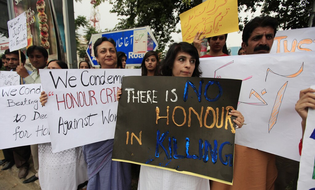 Members of civil society and the Human Rights Commission of Pakistan hold placards during a protest in Islamabad
