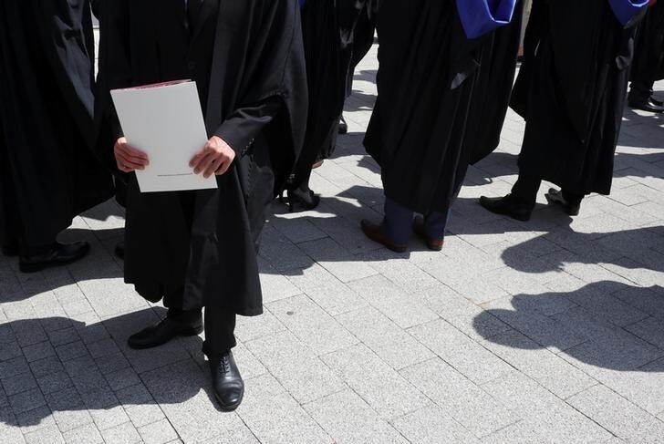 A Warwick University graduate holds a degree certificates on the day of a graduation ceremony in Warwick, Britain July 17, 2017. Picture taken July 17, 2017. REUTERS/Russell Boyce