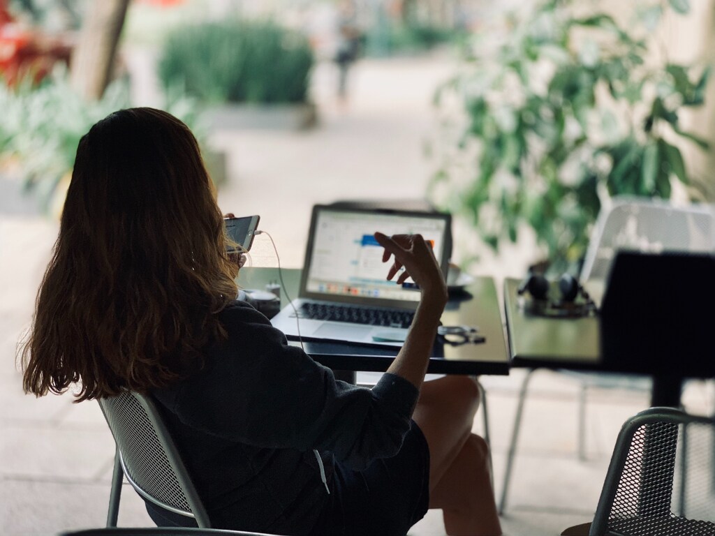 woman working on computer and phone