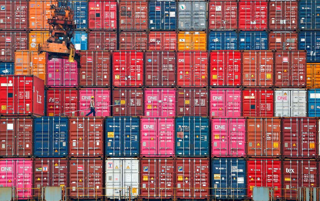 A worker walks on stacks of containers at the Tanjung Priok port in Jakarta, Indonesia, January 22, 2021. REUTERS/Ajeng Dinar Ulfiana TPX IMAGES OF THE DAY - RC2WCL9EYDE4