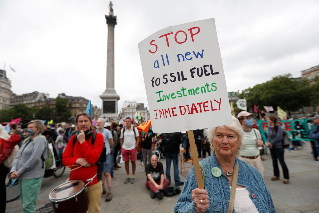 A demonstrator holds a sign during a protest of Extinction Rebellion climate activists at Trafalgar Square, in London, Britain August 23, 2021. REUTERS/Peter Nicholls - RC2XAP9QT57K