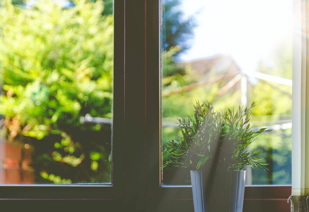 a picture of a window with sunlight streaming in to the room