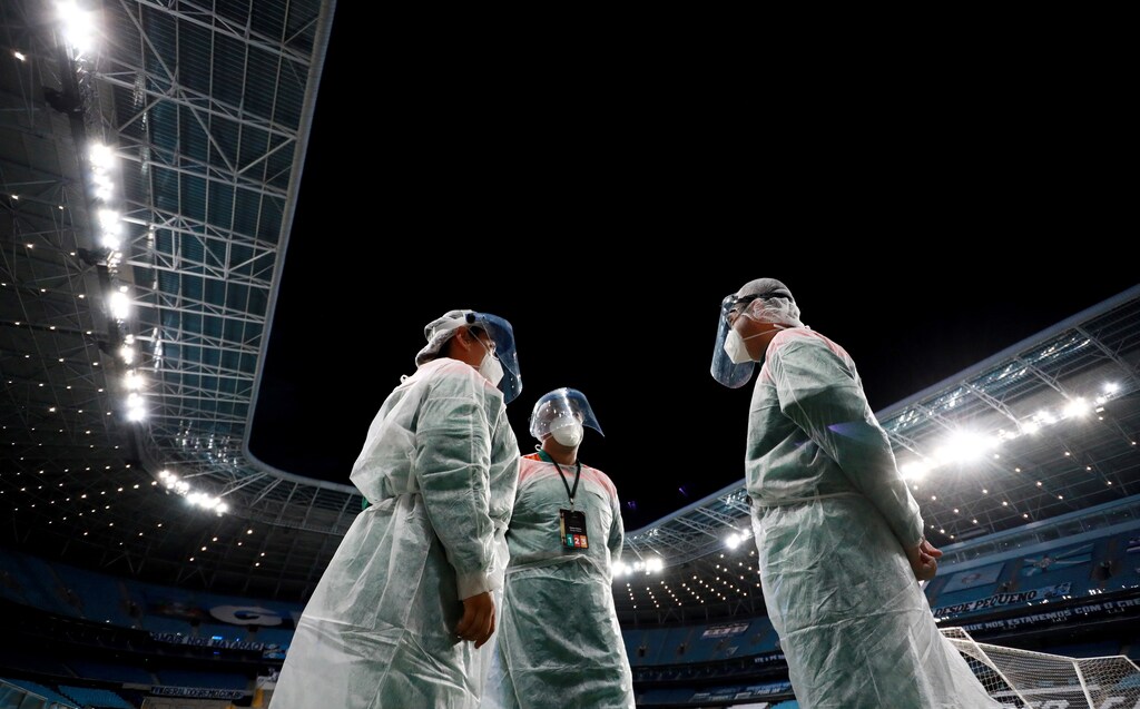 Soccer Football - Copa Libertadores - Qualification - First Leg - Gremio v Ayacucho - Arena do Gremio, Porto Alegre, Brazil - March 10, 2021 Staff wearing protective gear before the match Pool via REUTERS/Silvio Avila TPX IMAGES OF THE DAY - HP1EH3B010S7E