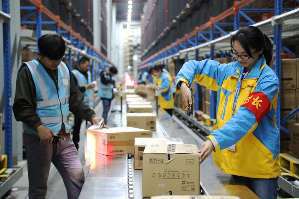 Employees scan parcels at a Suning logistics base in Nanjing, China, ahead of the Singles' Day shopping festival