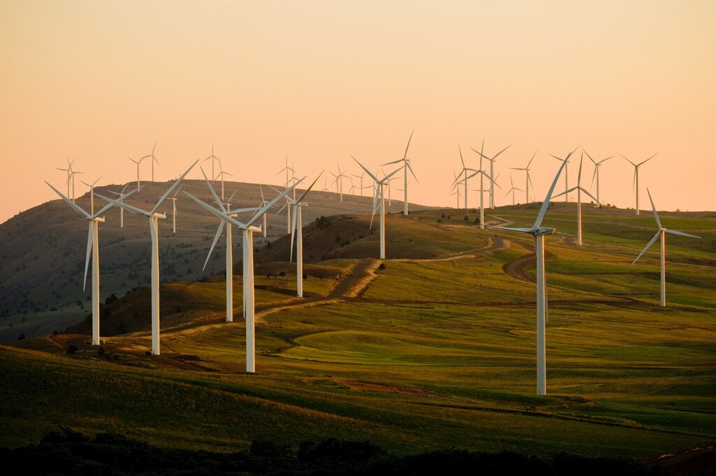 Multiple wind turbines on a field.