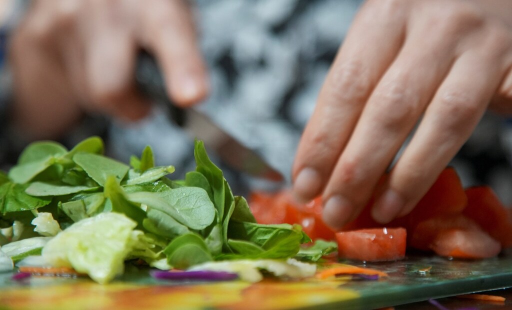 a close up of a leafy salad being prepared