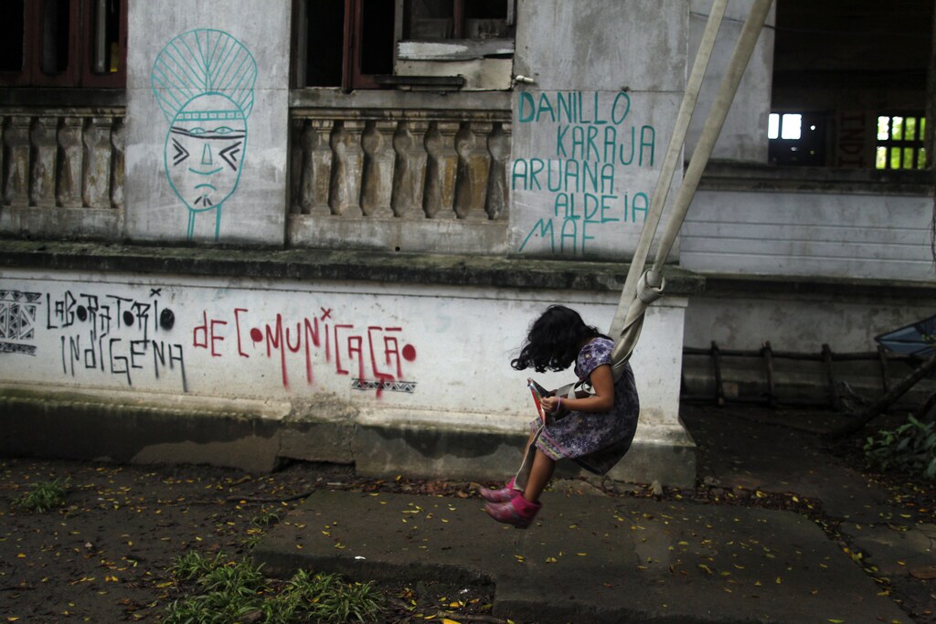 A girl balances on a swing at the Indian Museum in Rio de Janeiro January 14, 2013.