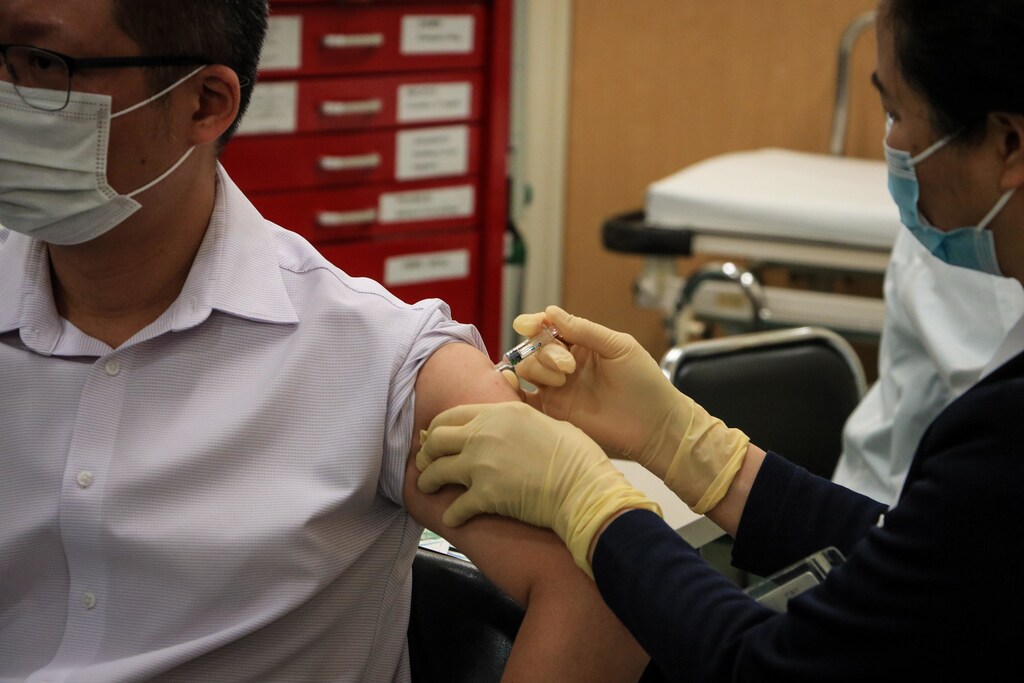 man receiving covid-19 vaccine