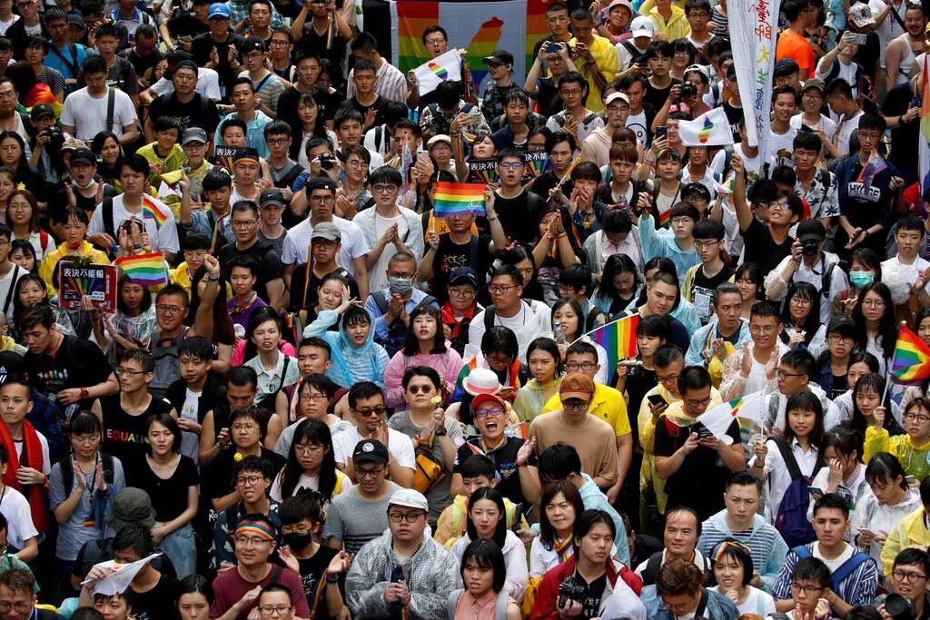 Same-sex marriage supporters hold umbrellas and rainbow flags as they take part in a rally during a parliament vote on three different draft bills of a same-sex marriage law, outside the Legislative Yuan in Taipei, Taiwan May 17, 2019. REUTERS/Tyrone Siu - RC14C8099DA0