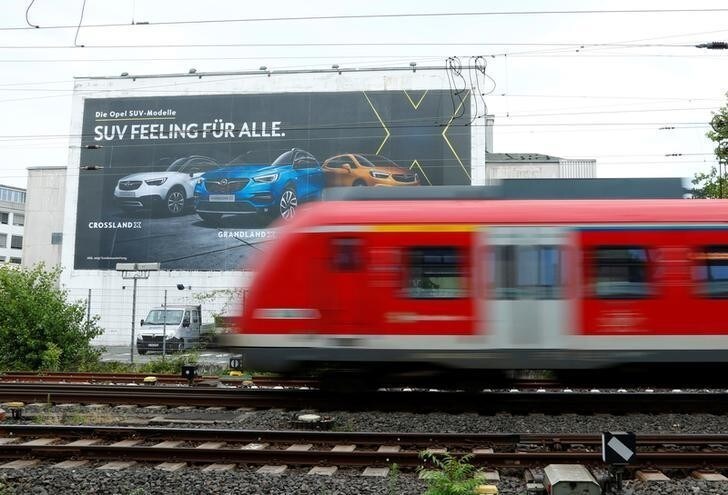 A train drives past an Opel advertisement poster in Ruesselsheim, Germany July 5, 2018. REUTERS/Ralph Orlowski