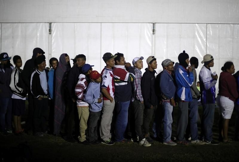 Migrants, part of a caravan of thousands traveling from Central America en route to the United States, queue for registration in a makeshift camp in Mexico City, Mexico, November 5, 2018.