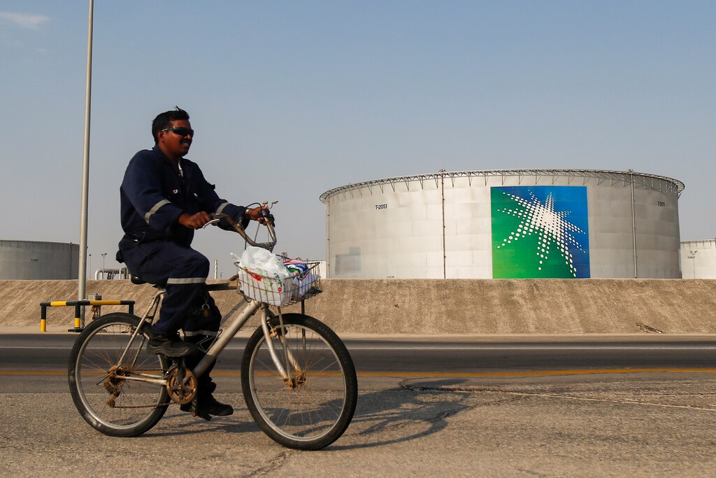 An employee rides a bicycle next to oil tanks at Saudi Aramco oil facility in Abqaiq, Saudi Arabia October 12, 2019. REUTERS/Maxim Shemetov - RC112617AD30