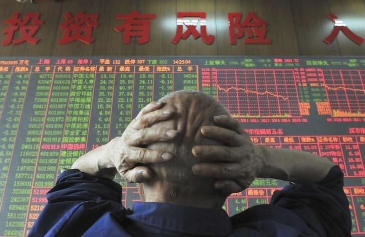 An investor looks at an electronic board showing stock information at a brokerage house in Taiyuan, Shanxi province, June 19, 2008. China's main stock index tumbled 6.54 percent to a fresh 16-month closing low on Thursday after hoped-for government steps to support the market failed to materialise. The words on the wall reads: "Investments have its risks". REUTERS/China Daily (CHINA). CHINA OUT. NO COMMERCIAL OR EDITORIAL SALES IN CHINA.