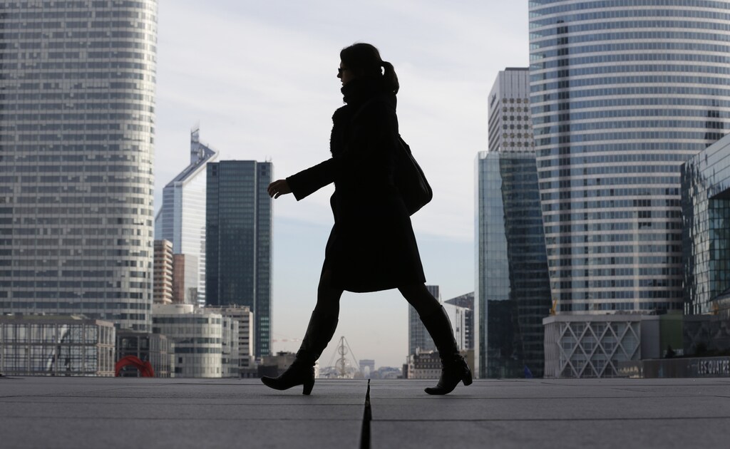 A Businesswoman is silhouetted as she makes her way under the Arche de la Defense, in the financial district west of Paris, November 20, 2012. France said its economy was sound and reforms were on track after credit ratings agency Moody's stripped it of the prized triple-A badge due to an uncertain fiscal and economic outlook. Monday's downgrade, which follows a cut by Standard & Poor's in January, was expected but is a blow to Socialist President Francois Hollande as he tries to fix France's finances and revive the euro zone's second largest economy.