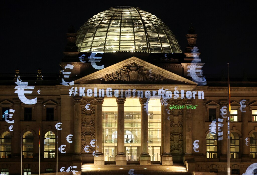 Greenpeace activists project a slogan that reads "No money for yesterday" on the Reichstag building, June 3, 2020.
