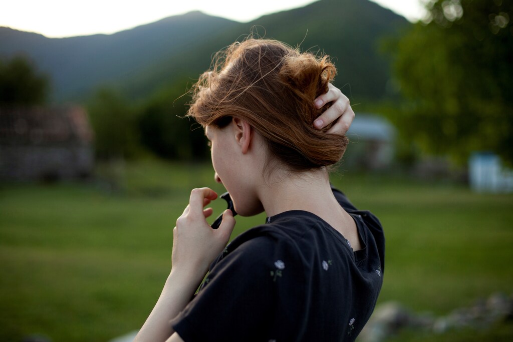 Mariam Kebadze, 16, fixes her hair during an evening walk along Alazani river in Jokolo village of Pankisi, Georgia, May 31, 2019. Mariam used to live with her father in Telavi and moved to Pankisi where she now lives and studies to support her mother Leila Achishvili who is running a guesthouse. "It's really boring sometimes here, there's not much to do in the village because it's the same routine all the time - school, classes, jogging by the river sometimes. Girls don't go outside at night because they are embarrassed and sometimes I really miss going for a walk in the evening, I like nights," she said. "One of my dreams is to live somewhere in the mountains, maybe in Switzerland. I read about a music festival in a forest there with beautiful lights at night, and people just dancing and laughing, they are so free and cheerful." REUTERS/Ekaterina Anchevskaya SEARCH "PANKISI WOMEN" FOR THIS STORY. SEARCH "WIDER IMAGE" FOR ALL STORIES. - RC1FFD6E02B0