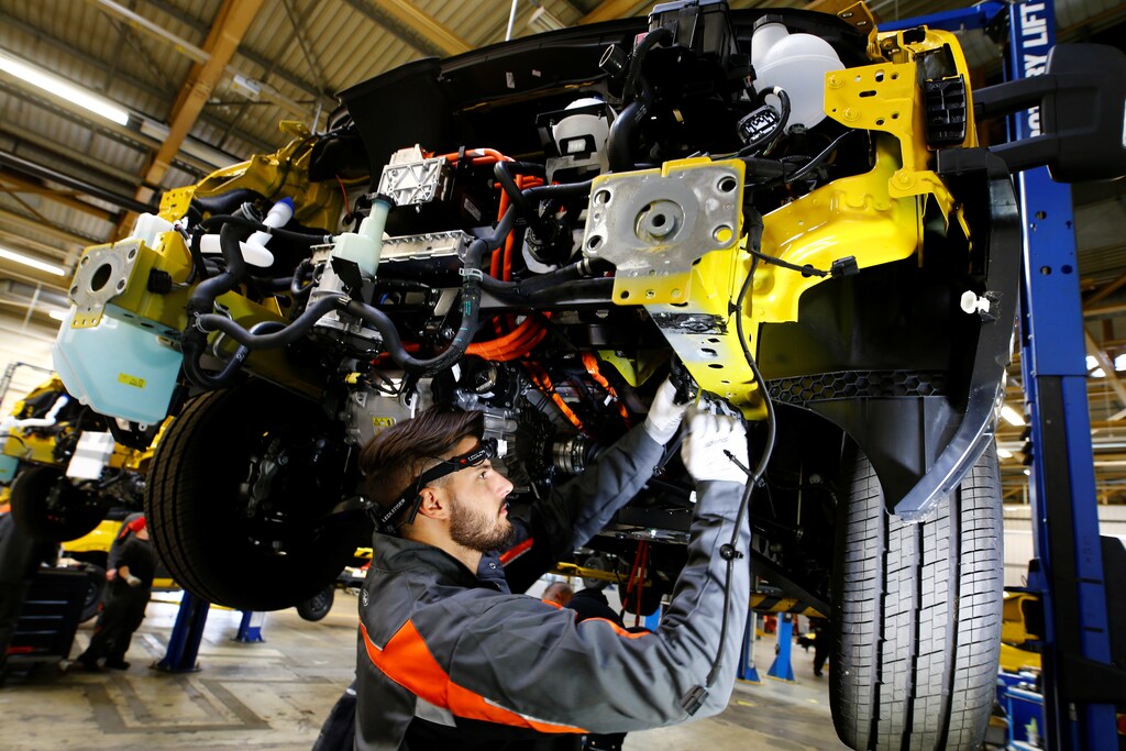A worker of Ford Germany fixes the engine of a Streetscooter WORK XL electric van based on a Ford Transit at Ford's new manufacturing line in Cologne, Germany October 9, 2018. REUTERS/Wolfgang Rattay - RC1C56F8E760