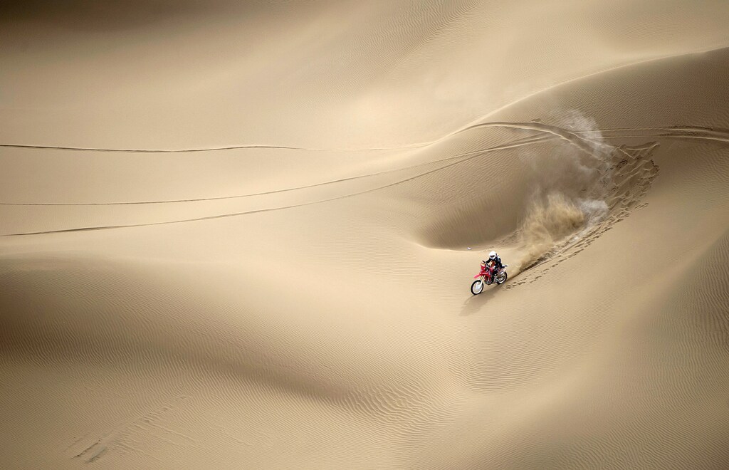 Wang Yirong of Hebei province rides his motorcycle in a desert during the China Taklimakan Rally and CCR Xinjiang Station, in Shanshan, Xinjiang Uighur Autonomous Region May 31, 2014. REUTERS/China Daily (CHINA - Tags: SPORT MOTORSPORT TPX IMAGES OF THE DAY) C