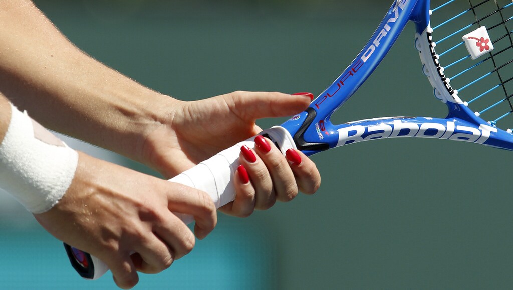 Agnieszka Radwanska of Poland grips her racquet as she receives serve from Elena Dementieva of Russia during their match at the Indian Wells WTA tennis tournament in Indian Wells, California March 17, 2010. REUTERS/Kevin Lamarque (UNITED STATES - Tags: SPORT TENNIS) - RTR2BR6I